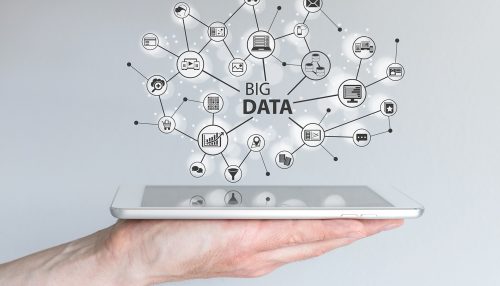 Big data and mobile computing concept. Hand holding silver table